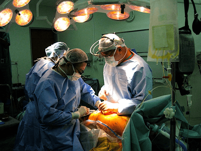Surgeons operating in theatre